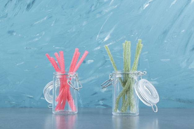 Sour jelly candies in glass containers.