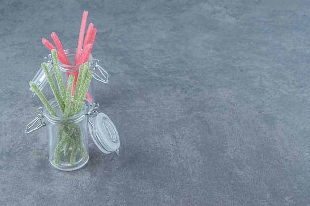 Free Photo sour jelly candies in glass containers.