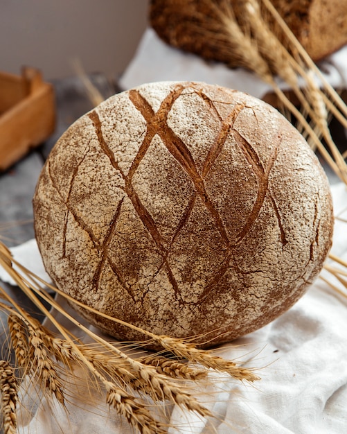 Free photo sourdough bread with wheat on table