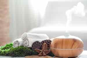 Free photo spa composition with the aroma of a modern oil diffuser with body care products.