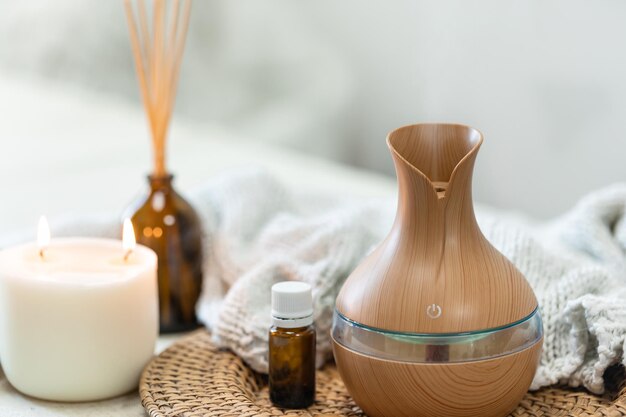 Spa composition with aroma oil diffuser lamp on a blurred background