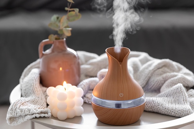 Spa composition with aroma oil diffuser lamp and candle on a blurred background