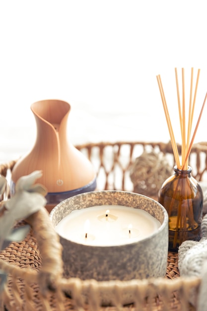 Free photo spa composition with aroma oil diffuser lamp and candle on a blurred background