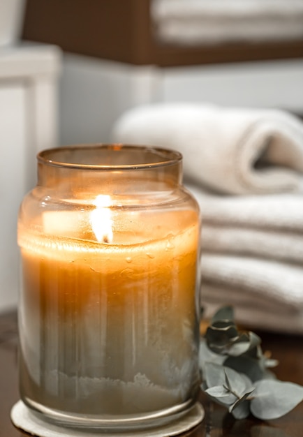 Free Photo spa composition with burning candle, bath towels close up. aromatherapy concept.