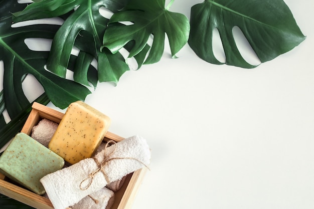 Spa composition with tropical leaves on white background