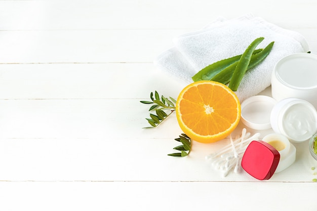 Spa concept with salt, mint, lotion, towel on white background