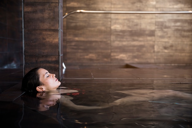 Spa concept with woman relaxing in water