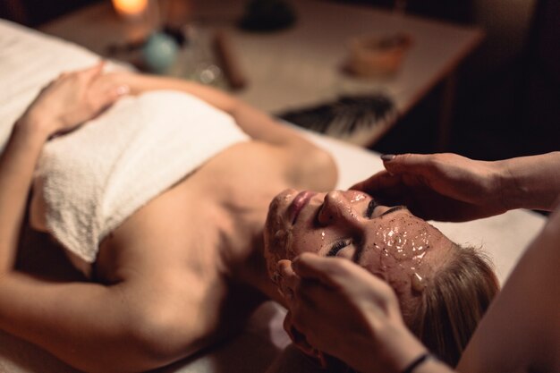 Spa concept with woman with creme in face