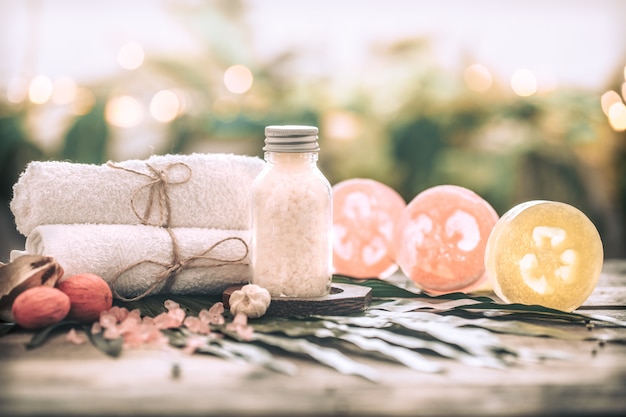 Free Photo spa handmade soap with white towels and sea salt, composition on tropical leaves, wooden background