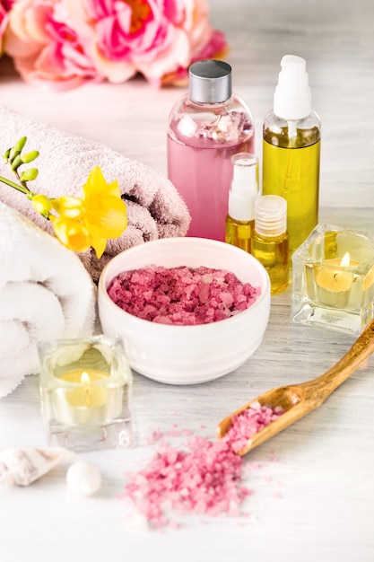 Spa setting with pink roses and aroma oil, vintage style