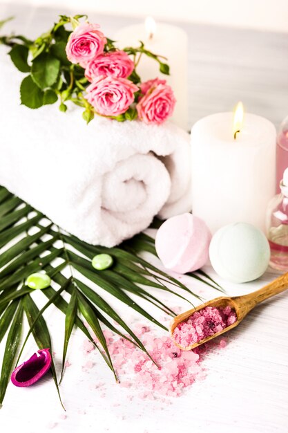 Spa setting with pink roses and aroma oil, vintage style