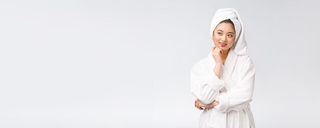 Spa skincare beauty Asian woman drying hair with towel on head after shower treatment Beautiful multiracial young girl touching soft skin