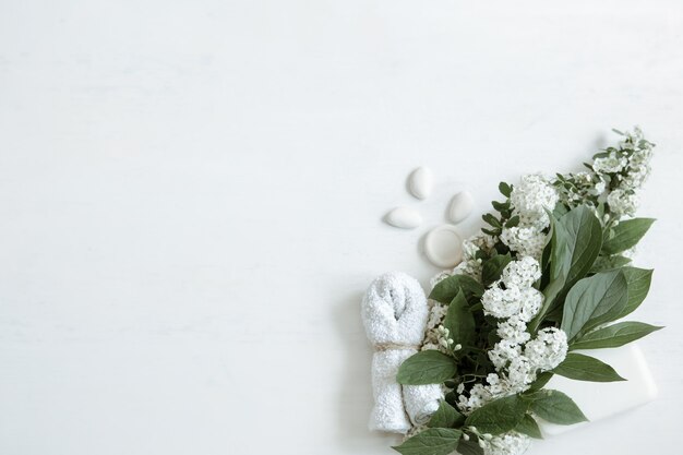 Spa still life with bath accessories, health and beauty products with fresh flowers