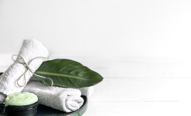 Spa still life with organic skincare, natural leaf and towels. 