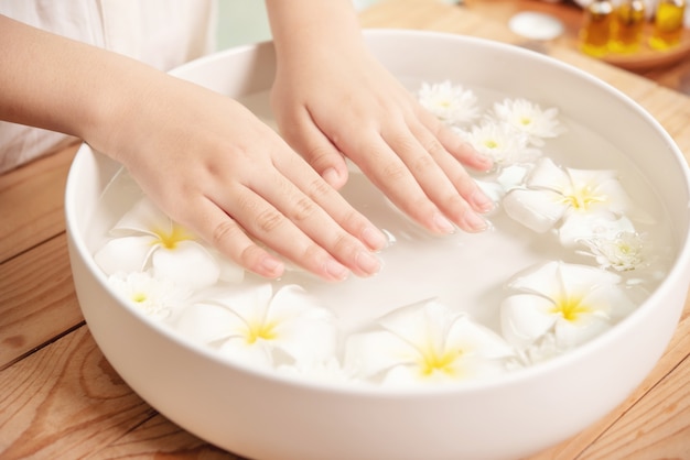 Free Photo spa treatment and product. white flowers in ceramic bowl with water for aroma therapy at spa.