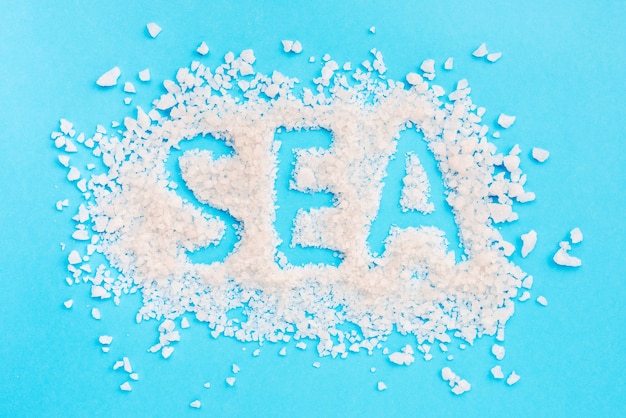 Free photo spa word written with bath salt on blue background