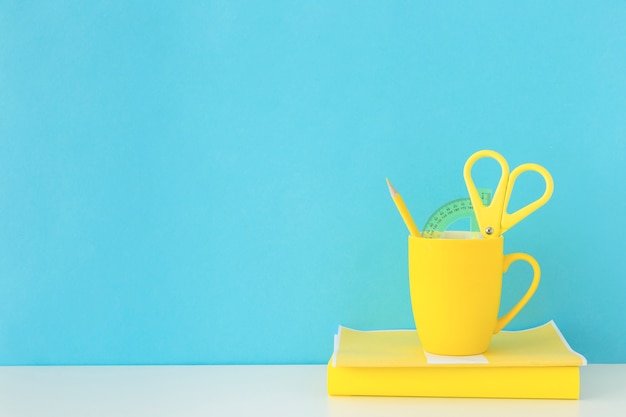 Spacious workplace with yellow mug and notebook