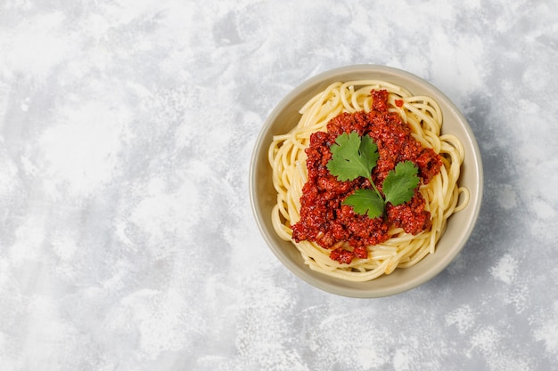 Spaghetti bolognese on grey concrete 