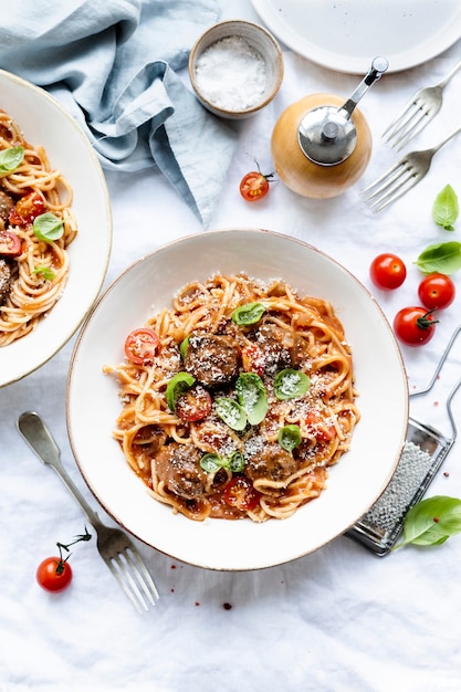 Spaghetti meatball topped with parmesan and basil food  