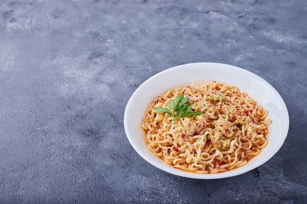 Spaghetti in a white plate .