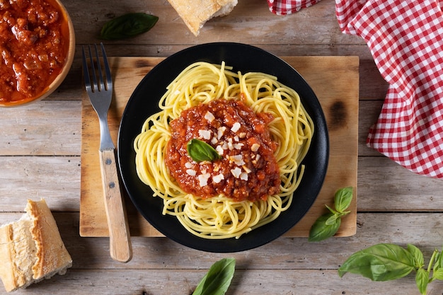 Spaghetti with bolognese sauce on wooden tablexA