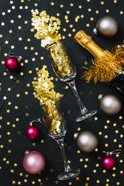 Spangles in glasses with baubles on table 