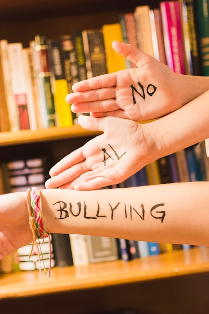 Free photo spanish message against bullying on children's hands