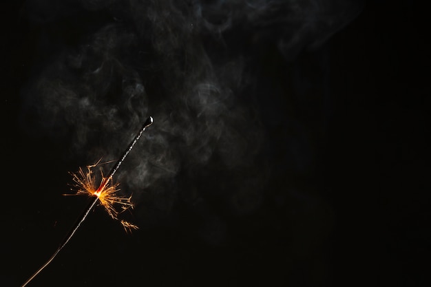 Sparkler flaming on black background