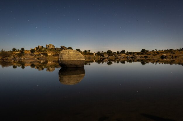 Sparkling night landscape with moonlight in the Barruecos Natural Area