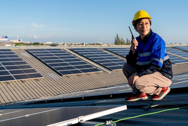 Specialist technician professional engineer with laptop and tablet maintenance checking installing solar roof panel on the factory rooftop under sunlight Engineers holding tablet check solar roof