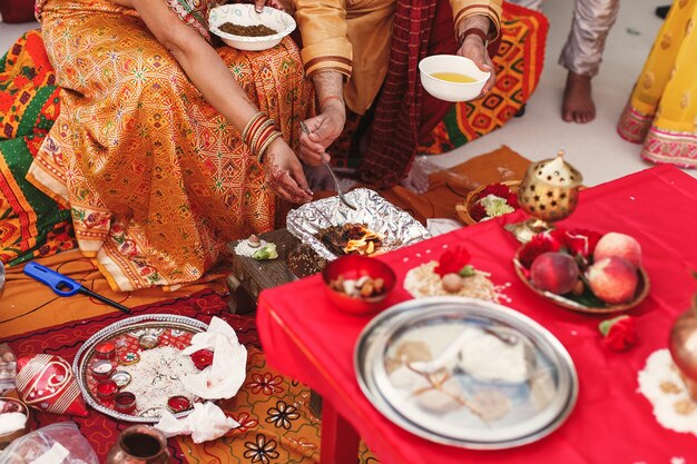 Species and fruits surround Indian parents preparing paste