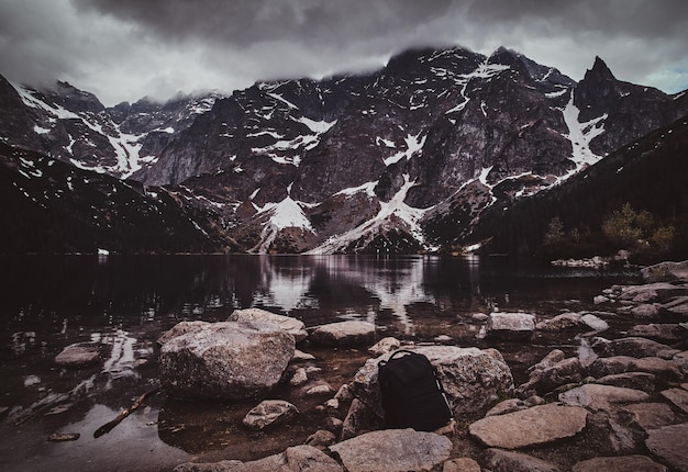 Free photo spectacular view to the beautiful mountains with mirroed reflection and clouds at sunrise time.