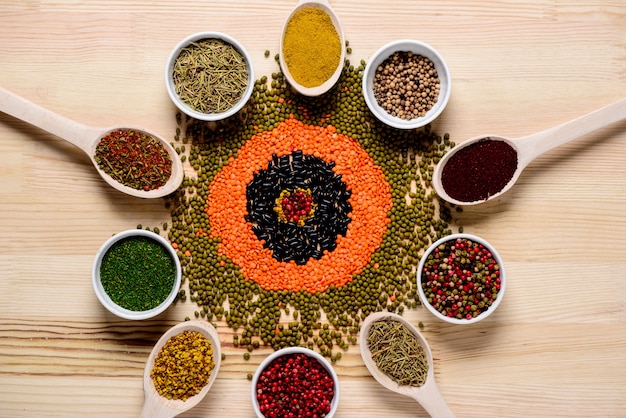 Free photo spices in spoons and on wooden table