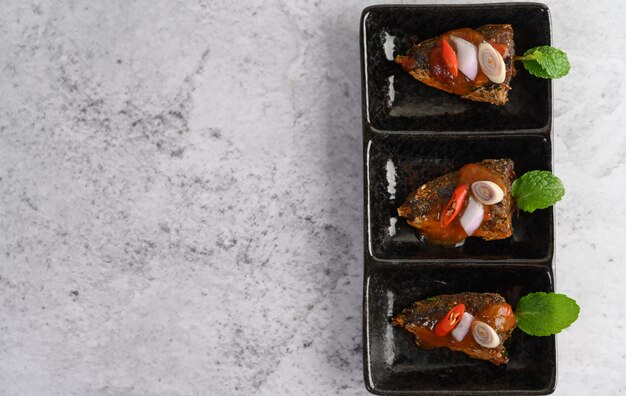 Spicy sardines in ceramic tray