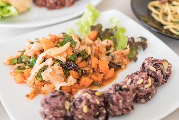 Spicy vegan salad with sticky berry and grain rice