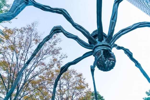 Free Photo a spider sculpture by louise bourgeois, situated at the base of mori tower building in roppongi hills