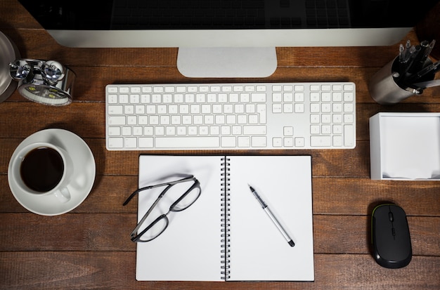 Spiral notepad with black coffee and spectacle