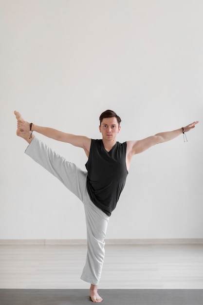 Free Photo spiritual young man practicing yoga indoors