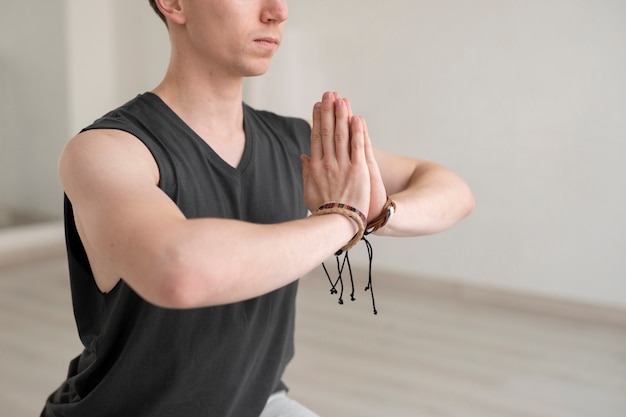 Free Photo spiritual young man practicing yoga in sportswear