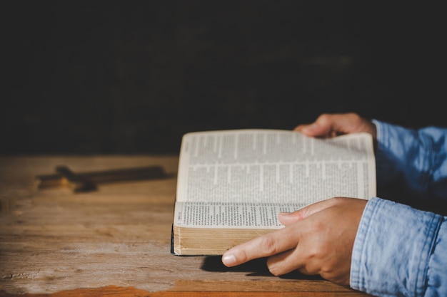 Free Photo spirituality and religion, hands folded in prayer on a holy bible in church concept for faith.