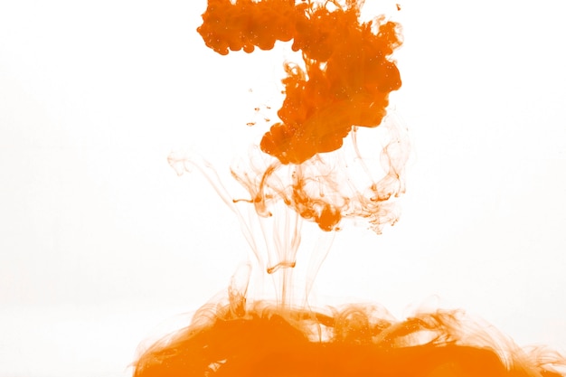 Free photo splash of orange pigment