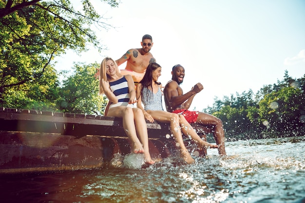 Splashing water and laughting on the pier on river