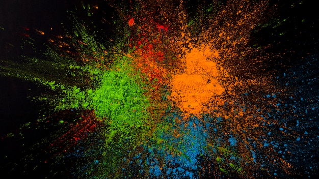 Free Photo splatted green,blue and orange color on black background