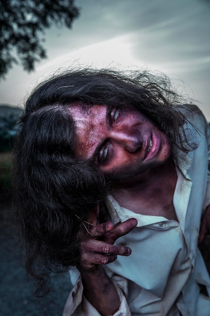 Free Photo spooky female zombie outdoors