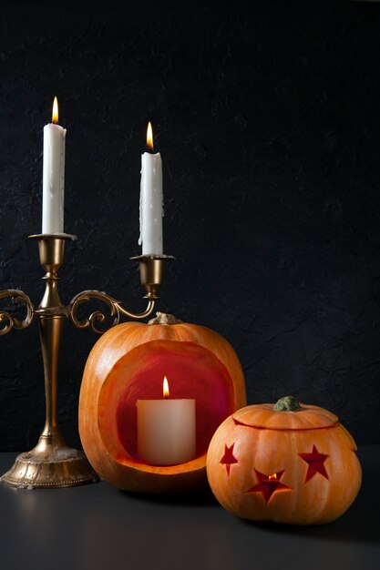 Spooky halloween carved pumpkin lantern with candelabra