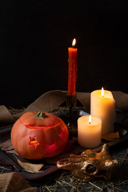 Free photo spooky halloween carved pumpkin lantern with candelabra