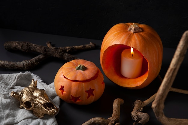 Free photo spooky halloween carved pumpkin lantern with lit candle