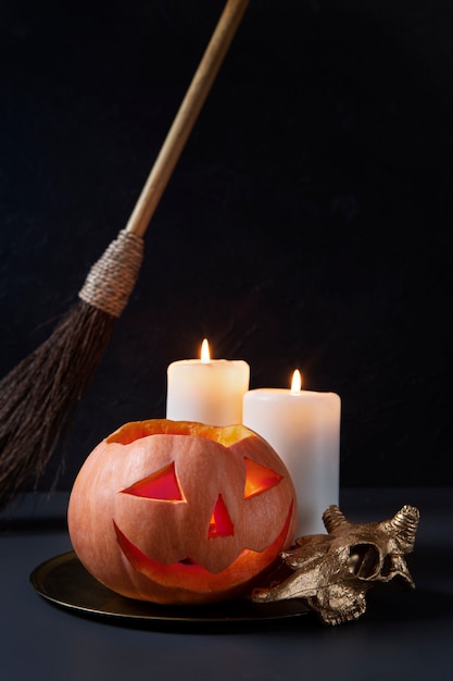 Free photo spooky halloween carved pumpkin lantern with lit candles