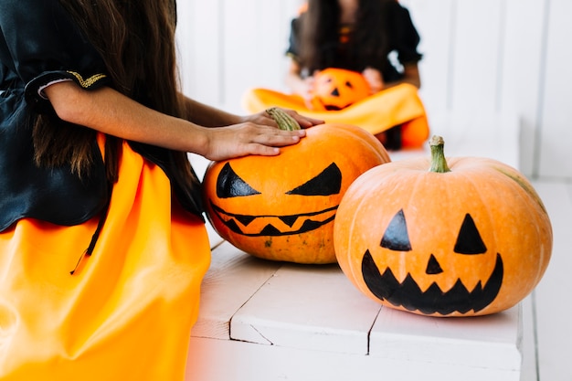 Free Photo spooky painted halloween pumpkins with little witches