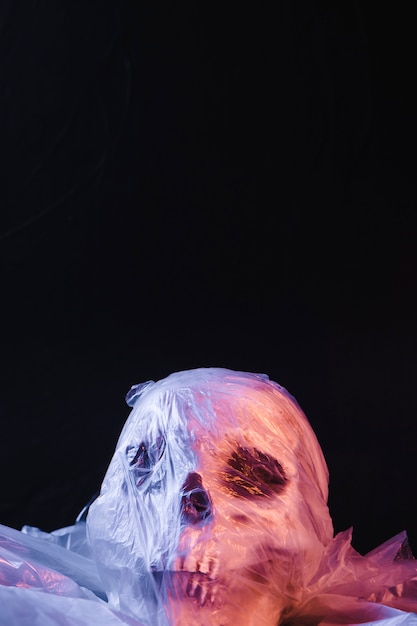 Free Photo spooky skull in plastic material illuminated by purple light